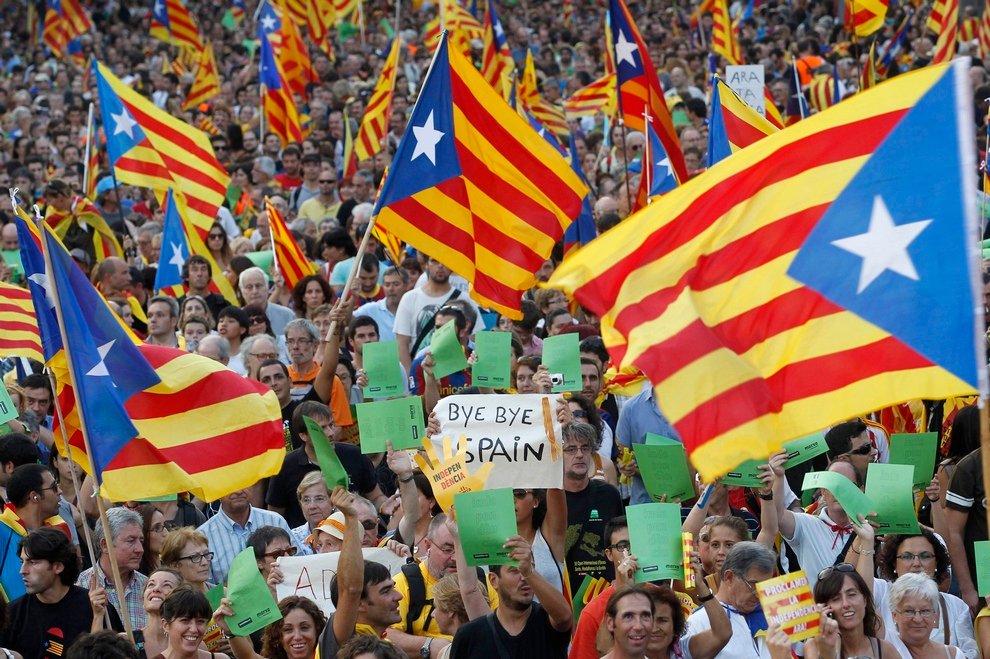 Marchers wave Catalonian nationalist flags as they demonstrate during Catalan National Day in Barcelona