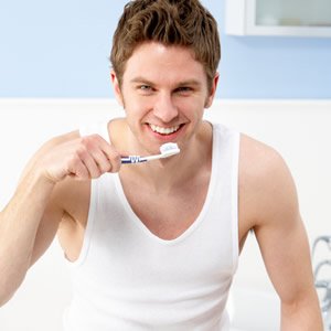 парень чистит зубы