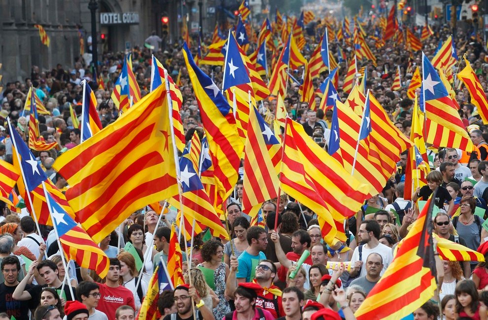 Marchers wave Catalonian nationalist flags as they demonstrate during Catalan National Day in Barcelona