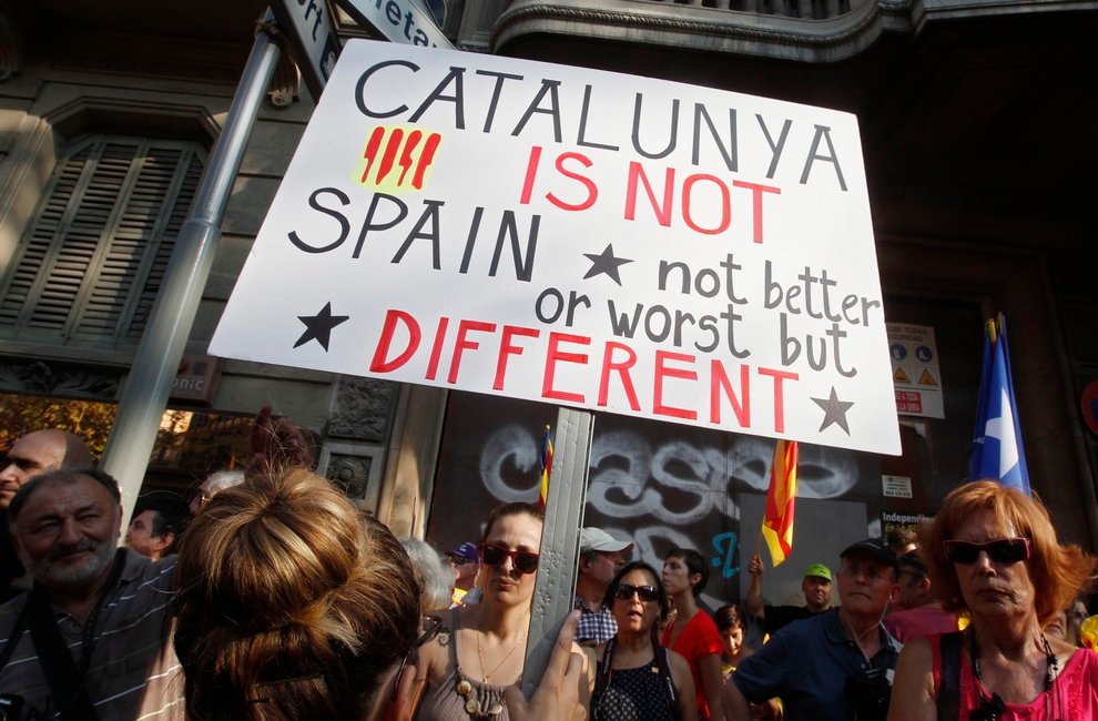 A marcher holds a placard during a demonstration on Catalan National Day in Barcelona