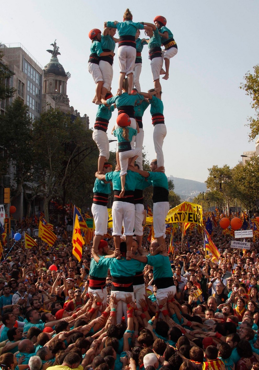A group of Castellers form a human tower called a "Castell" during a demonstration on Catalan National Day in Barcelona